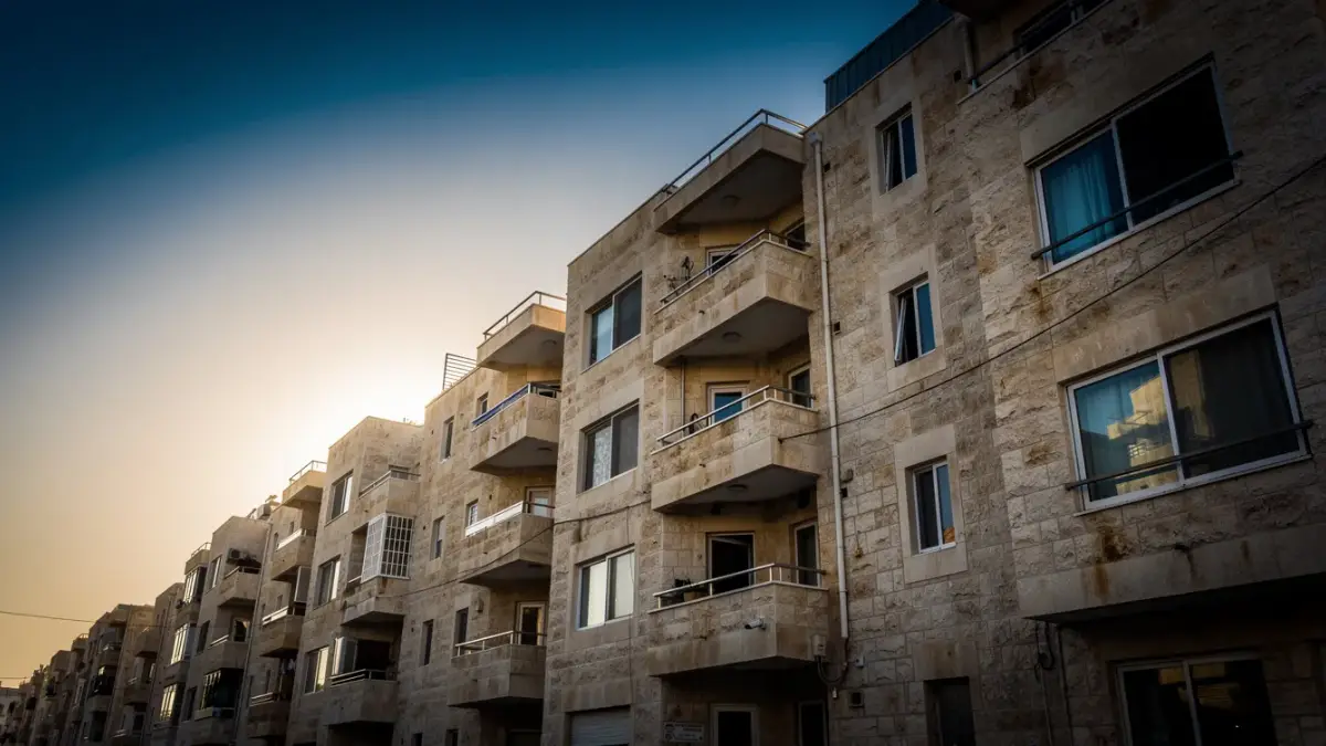 שורת בנייני מגורים ישראליים עם מרפסות באור שקיעה